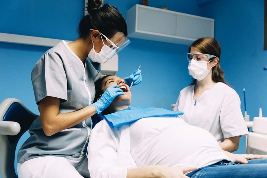 Dental professionals examining a woman's teeth before a cosmetic treatment in Columbus, GA