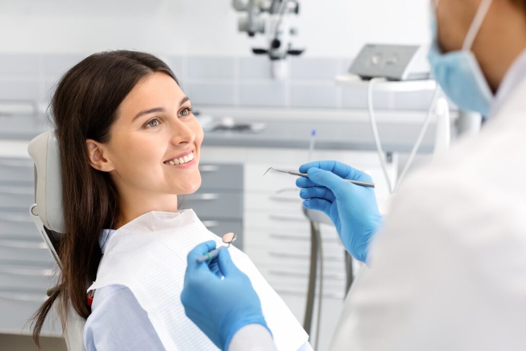 A young woman sitting in a dental chair during cosmetic dental treatment in Columbus, GA