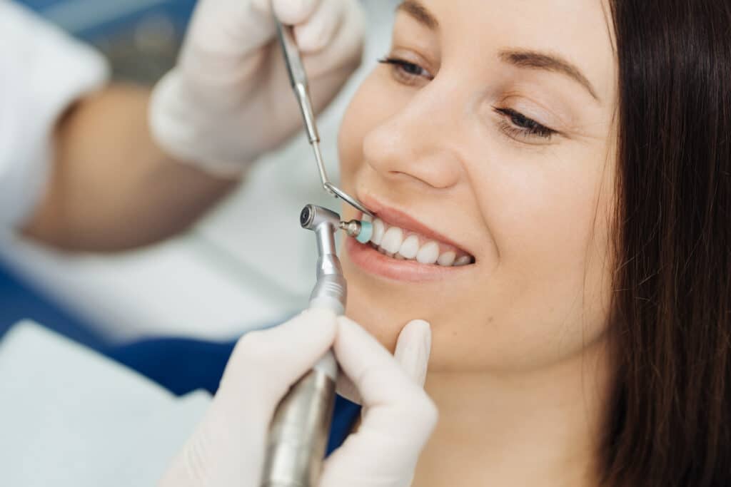 Dentist doing scaling and brushing procedure