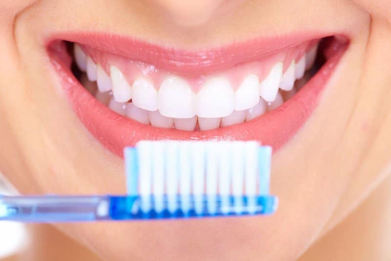 Patient smiling with a toothbrush