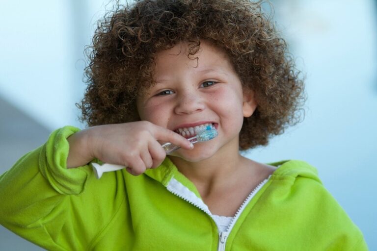curly head brushing teeth1, “Say Cheese” with the Children’s Dentist in Hamilton, GA