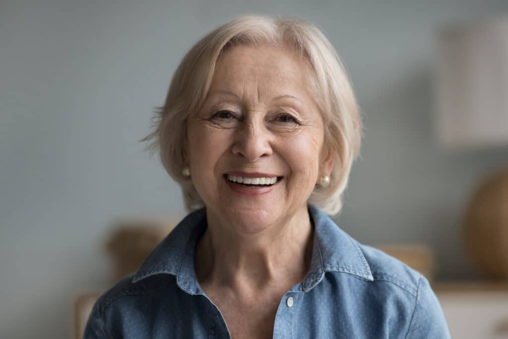 older woman smiling, Dentures
