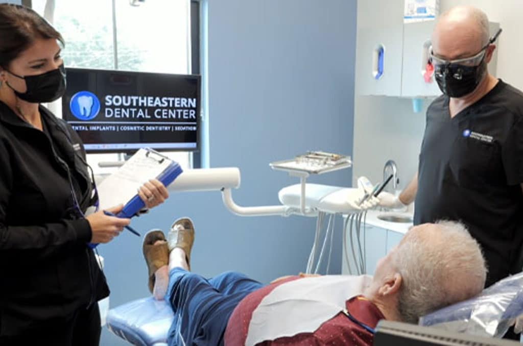 Doctor Arrington speaking with a dental patient.