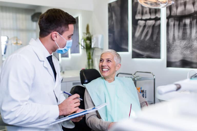 Woman learning more about her dental implants