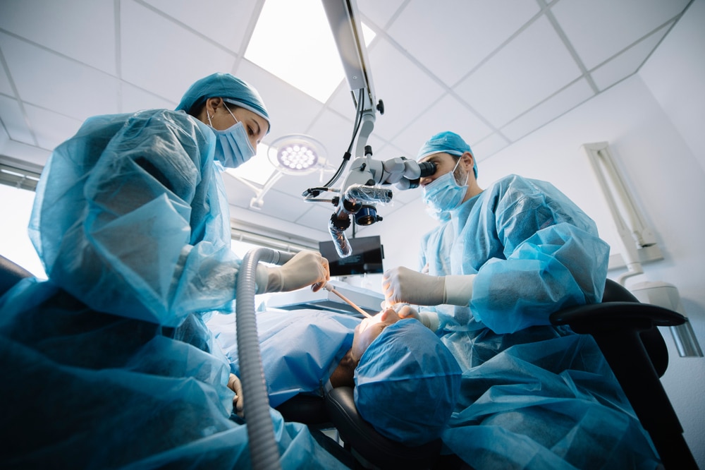A dentist and his assistant during a gummy smile correction surgery