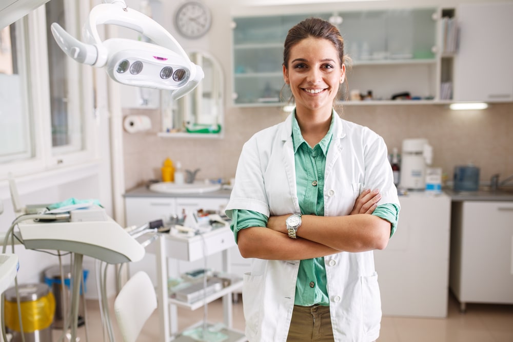 A smiling female dentist in her office