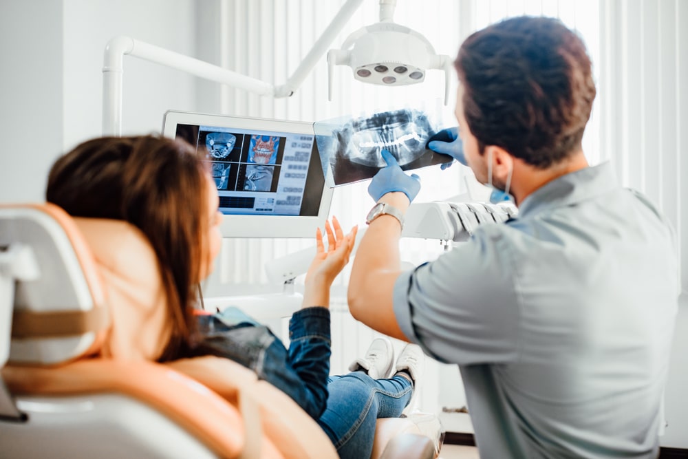 A dentist showing scan results to his patient
