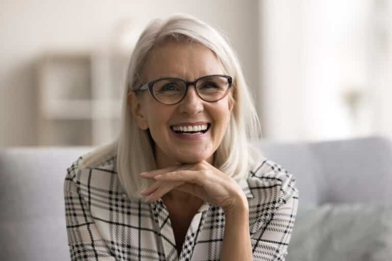 woman smiling, Dental Implants vs. Dentures: What's the Best Tooth Replacement Option?
