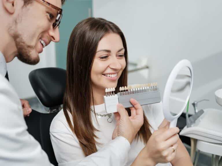 dentist showing veneer palette, What Are The Different Types Of Veneers? Options, Costs & Pros and Cons