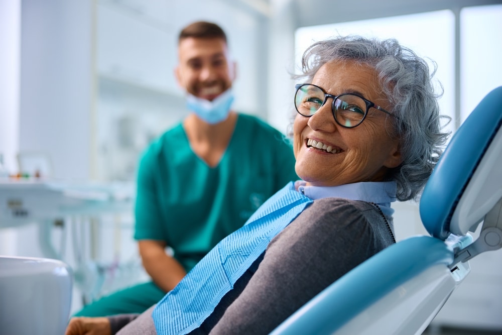 A smiling elderly patient in a dentist’s office