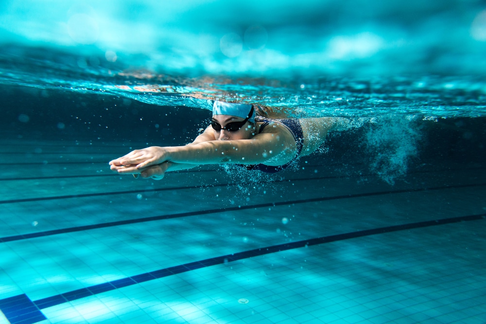 A female swimmer under the water in a swimming pool